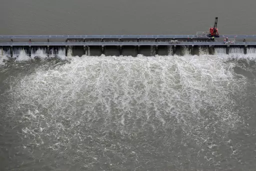 Workers open bays of the Bonnet Carre Spillway to divert rising water from the Mississippi River to Lake Pontchartrain, upriver from New Orleans, in Norco, La., May 10, 2019. The U.S. Army Corps of Engineers appealed a federal judge’s ruling Monday, March 20, 2023, that itmust consult with federal fisheries experts before opening the spillway that protects New Orleans from Mississippi River flooding. (AP Photo/Gerald Herbert, File)
