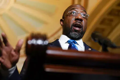 Sen. Raphael Warnock, D-Ga., speaks during a news conference after the weekly Democratic policy luncheon on Capitol Hill in Washington, Tuesday, Dec. 7, 2021.  A bipartisan group of Georgia lawmakers is asking congressional budget writers to reject the Biden administration's plan to close a training facility for military pilots. Five Georgia congressmen led by Warnock sent a letter last week asking key members of the House and Senate appropriations committees to restore $11.5 million to keep ope