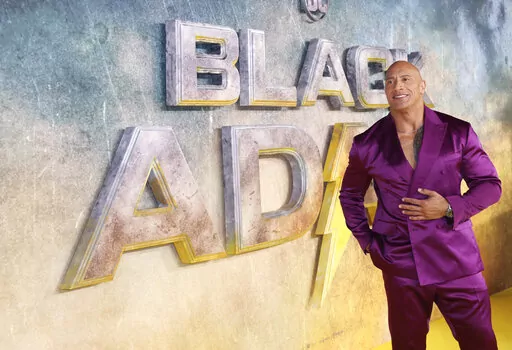 Dwayne Johnson poses for photographers upon arrival for the premiere of the film 'Black Adam' on Tuesday, Oct. 18, 2022, in London. (Photo by Vianney Le Caer/Invision/AP)