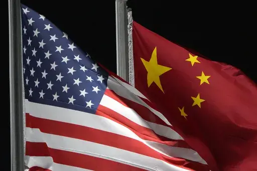 The American and Chinese flags wave at Genting Snow Park ahead of the 2022 Winter Olympics, in Zhangjiakou, China, on Feb. 2, 2022. A top White House official on Wednesday said at least eight U.S. telecom firms and dozens of nations have been impacted by a Chinese hacking campaign. (AP Photo/Kiichiro Sato, File)