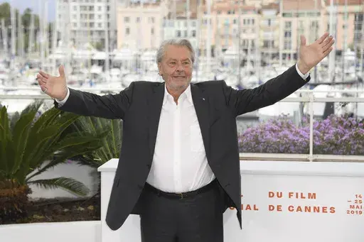 FILE- In this May 19, 2019 file photo, French actor Alain Delon poses for photographers at the photo call for his honorary Palme D'Or award at the 72nd international film festival, Cannes, southern France. Alain Delon, the internationally acclaimed French actor who embodied both the bad guy and the policeman and made hearts throb around the world, has died at age 88, French media reported. (Photo by Arthur Mola/Invision/AP, File)