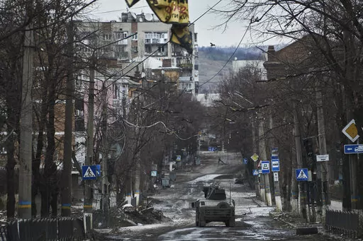 Ukrainian soldiers ride in a Humvee in Bakhmut, Donetsk region, Ukraine, Wednesday, Dec. 21, 2022. (AP Photo/Libkos, File)