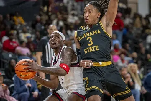 Jackson State guard Keiveon Hunt, left, goes for the basket against Jackson State guard Jayme Mitchell Jr. (3) during the first half of an NCAA basketball game in the championship of the Southwest Athletic Conference Championship tournament Saturday, March 15, 2025, in College Park, Ga. (AP Photo/Erik Rank)