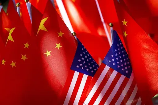 American flags are displayed with Chinese flags on top of a trishaw on Sept. 16, 2018, in Beijing. (AP Photo/Andy Wong, File)