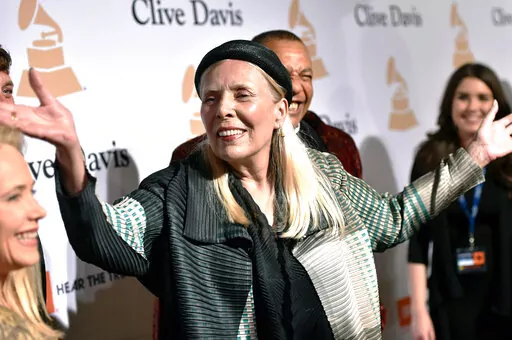 Joni Mitchell arrives at the 2015 Clive Davis Pre-Grammy Gala in Beverly Hills, Calif. Feb. 7, 2015. Joni Mitchell said Friday, Jan. 28, 2022 she seeks to remove all of her music in Spotify in solidarity with Neil Young, who ignited a protest against the streaming service for airing a podcast that featured a figure who has spread misinformation about the coronavirus. (Photo by John Shearer/Invision/AP, File)