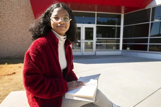 Rachel McBride poses for a portrait in Atlanta on Sunday, March 13, 2022. For Black girls, the possibility of Ketanji Brown Jackson being the first Black woman on the Supreme Court is a moment of promise, hope and the breaking of yet another barrier. McBride likened the moment more to a glass elevator than a glass ceiling, moving one level up, while keeping in mind the many more levels left to go. (AP Photo/Hakim Wright Sr.)