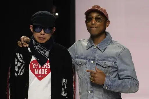 Pharrell Williams, right, walks with with Nigo, artistic designer for Kenzo, with who co-creates a collection, after the men's Louis Vuitton Fall-Winter 2025-2026 collection, that was presented in Paris, Tuesday, Jan. 21, 2025. (AP Photo/Michel Euler)
