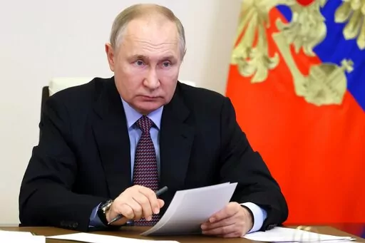 Russian President Vladimir Putin takes part in a ceremony to launch new and renovated transport infrastructure via videoconference at the Novo-Ogaryovo residence outside Moscow, Russia, Tuesday, Dec. 13, 2022. (Mikhail Metzel, Sputnik, Kremlin Pool Photo via AP)
