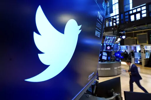 The logo for Twitter appears above a trading post on the floor of the New York Stock Exchange, Nov. 29, 2021. Twitter said Friday April 22, 2022, it will no longer allow advertisers on its site who deny the scientific consensus on climate change, echoing a policy already in place at Google. (AP Photo/Richard Drew, File)