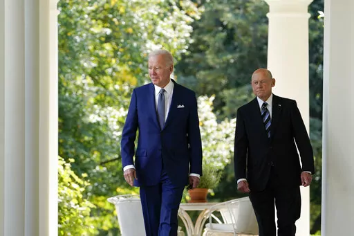 President Joe Biden walks with Bob Parant, Medicare beneficiary with Type 1 diabetes, as they arrive to speak at an event on health care costs, in the Rose Garden of the White House, Tuesday, Sept. 27, 2022, in Washington. (AP Photo/Susan Walsh)