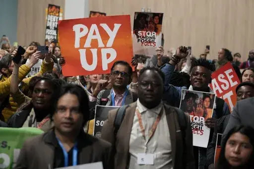 Activists participate in a demonstration for climate finance during the COP29 U.N. Climate Summit, Saturday, Nov. 16, 2024, in Baku, Azerbaijan. (AP Photo/Rafiq Maqbool)