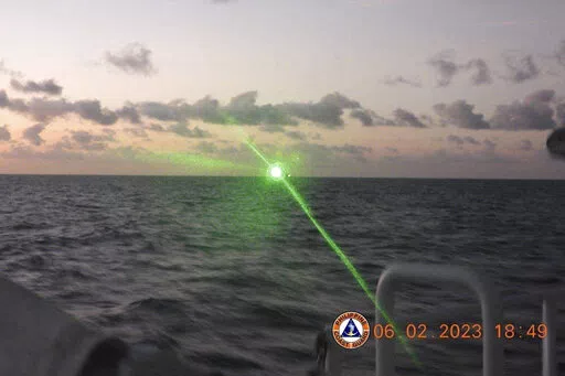 This photo provided by the Philippine Coast Guard shows a green military-grade laser light from a Chinese coast guard ship in the disputed South China Sea, Monday, Feb. 6, 2023. The Philippines on Monday, Feb. 13, accused a Chinese coast guard ship of hitting a Philippine coast guard vessel with a military-grade laser and temporarily blinding some of its crew in the disputed South China Sea, calling it a "blatant" violation of Manila's sovereign rights. (Philippine Coast Guard via AP)