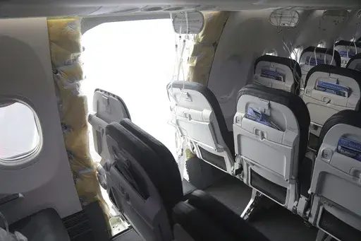 This image taken Sunday, Jan. 7, 2024, and released by the National Transportation Safety Board, shows the section of a a Boeing 737 Max where a door plug fell while Alaska Airlines Flight 1282 was in flight. (NTSB via AP, File)