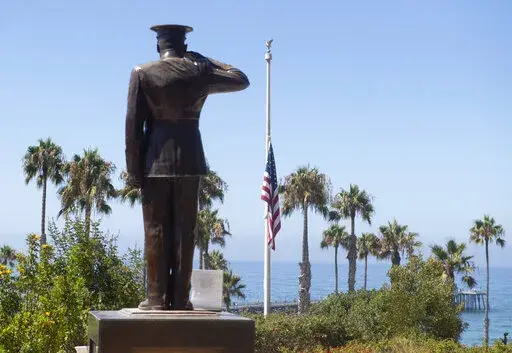 In this July 31, 2020, file photo, the U.S. flag is seen lowered to half-staff at Park Semper Fi in San Clemente, Calif., after a seafaring assault vehicle sank off the coast of Southern California. A Marine Corps panel convenes Tuesday, Jan. 4, 2022, to decide if an officer should be discharged over the sinking of the amphibious assault vehicle that killed nine service members. (Paul Bersebach/The Orange County Register via AP, File)