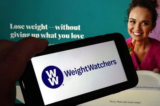 This image shows the logo of WeightWatchers on a mobile phone, and the company's website, in New York, Tuesday, March 7, 2023. WeightWatchers shares soared Tuesday after the company said it was getting into the prescription drug weight loss business with the acquisition of Sequence. (AP Photo/Richard Drew)