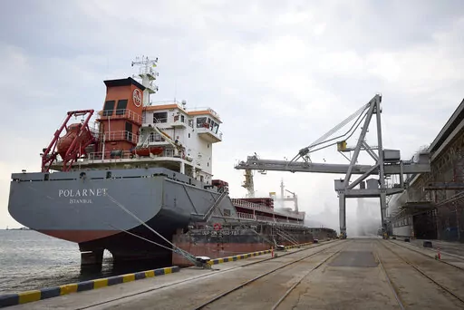In this photo provided by the Ukrainian Presidential Press Office, a Turkish Polarnet cargo ship is loading Ukrainian grain in a port in Odesa region, Ukraine, Friday, July 29, 2022. (Ukrainian Presidential Press Office via AP)