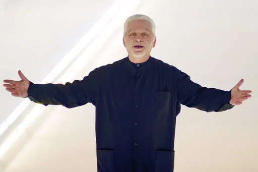 Franco-Spanish fashion designer Paco Rabanne acknowledges the applause at the end of his fall-winter 2000/2001 collection on March 3, 2000 in Paris, France. The Spanish-born pace-setting designer known for perfumes sold worldwide and his metallic, space-age fashions, has died, the group that owns his fashion house announced on its website Friday Feb.3, 2023. He was 88. (AP Photo/Remy de la Mauviniere, File)