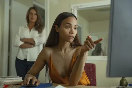 This image released by Netflix shows Karla Sofía Gascón, left, and Zoe Saldaña in a scene from "Emilia Pérez." (Netflix via AP)