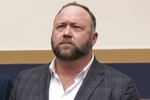 This Tuesday, Dec. 11, 2018, file photo shows radio show host and conspiracy theorist Alex Jones at Capitol Hill in Washington. Infowars host Jones has offered to pay $120,000 per plaintiff to resolve a lawsuit by relatives of Sandy Hook Elementary School shooting victims who said he defamed them by asserting the massacre never happened, according to court filings Tuesday, March 29, 2022. (AP Photo/J. Scott Applewhite, File)