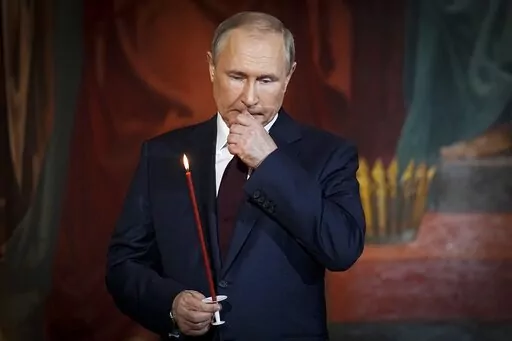 Russian President Vladimir Putin attends the Orthodox Easter service in the Christ the Savior Cathedral in Moscow, Russia, Sunday, April 24, 2022. Putin, who turned 70 on Friday, has found himself increasingly cornered with his army suffering humiliating defeats in Ukraine, hundreds of thousands of Russians fleeing his mobilization order and rifts opening up among his top lieutenants. (AP Photo/Alexander Zemlianichenko, Pool, File)