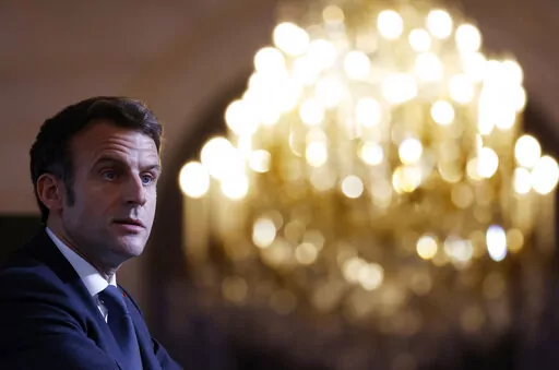 France's President Emmanuel Macron talks with representatives of families of repatriates from Algeria after the country's independence war with its colonial power, at the Elysee palace in Paris, Wednesday Jan. 26, 2022. French President Emmanuel Macron is pushing for dialogue with Russia, despite signs pointing to a potential war amid escalating tensions with Ukraine. It's part of France's post-World War II tradition of carving out its own geopolitical path. Macron is to talk with Russian Presid