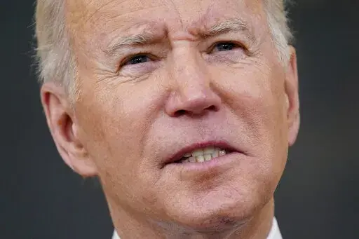 President Joe Biden speaks about the COVID-19 response and vaccinations, Tuesday, Dec. 21, 2021, in the State Dining Room of the White House in Washington. (AP Photo/Patrick Semansky)