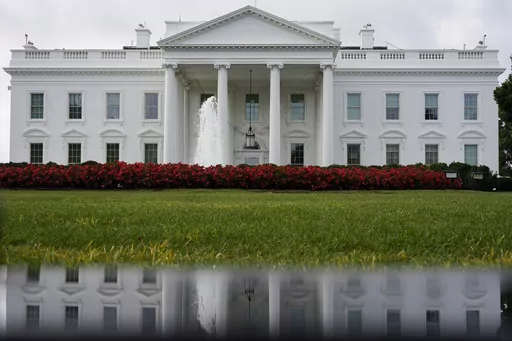 The White House is seen reflected in a puddle, Sept. 3, 2022, in Washington. The U.S. Senate confirmed Todd Gee on Friday, Sept. 29, 2023, to be the U.S. Attorney for the Southern District of Mississippi, putting him in charge of prosecuting the largest public corruption scandal in state history. (AP Photo/Carolyn Kaster, File)