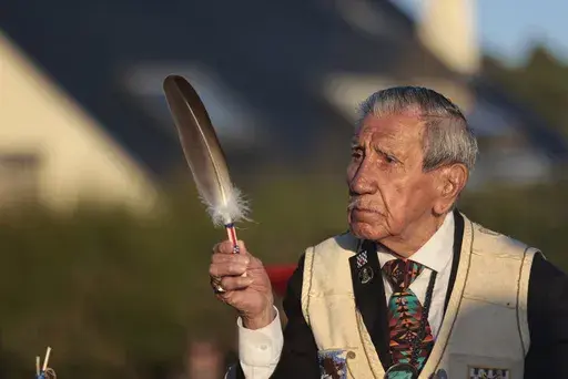FILE — WWII veteran Charles Shay, pays tribute to soldiers during a D-Day commemoration ceremony of the 78th anniversary for those who helped end World War II, in Saint-Laurent-sur-Mer, Normandy, France, Monday, June 6, 2022. On D-Day, Charles Shay was a 19-year-old Native American army medic who was ready to give his life — and actually saved many. Now 99, he's spreading a message of peace with tireless dedication as he's about to take part in the 80th celebrations of the landings in Norman