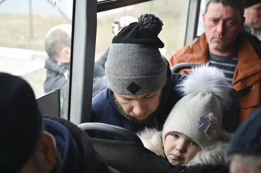 Refugees fleeing fleeing the military operation zone from the Mariupol area of Ukraine sit in a bus as they arrive at the border crossing in Veselo-Voznesenka, Russia, Monday, March 7, 2022. Russia announced yet another limited cease-fire and the establishment of safe corridors to allow civilians to flee some besieged Ukrainian cities. (AP Photo)