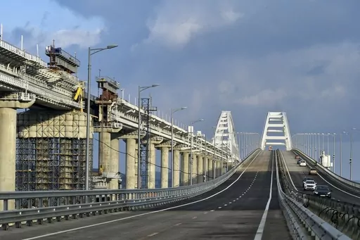 First cars and other vehicles drive on the Crimean Bridge connecting Russian mainland and Crimean peninsula over the Kerch Strait after restoration works, not far from Kerch, Crimea on in Kerch, Crimea, Thursday, Feb. 23, 2023. A top Ukrainian official on Sunday, April 2, 2023, outlined a series of steps the government in Kyiv would take after the country reclaims control of Crimea, including dismantling the strategic bridge that links the seized Black Sea peninsula to Russia. (Rosavtodor Press 