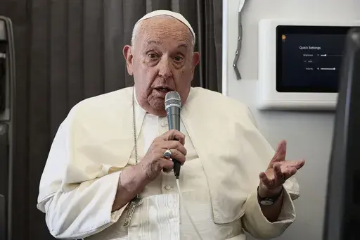 Pope Francis holds a news conference aboard the papal plane on his flight back after his 11-day journey across Southeast Asia and Oceania, Friday, Sept. 13, 2024. Francis went rogue plenty of times in Asia, and at the in-flight press conference coming back to Rome, he urged American Catholics to vote for who they thought was the "lesser evil" for president. (Guglielmo Mangiapane/Pool Photo via AP)
