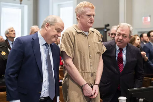 Alex Murdaugh speaks with his legal team before he is sentenced to two consecutive life sentences for the murder of his wife and son by Judge Clifton Newman at the Colleton County Courthouse on Friday, March 3, 2023 in in Walterboro, S.C. Murdaugh's lawyers have filed court papers that he plans to plead guilty in federal court to charges he stole money from clients. (Joshua Boucher/The State via AP, File, Pool)