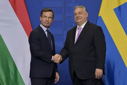 Sweden's Prime Minister Ulf Kristersson, left, shakes hands with his Hungarian counterpart Viktor Orban at the Carmelite Monastery in Budapest, Hungary, Friday, Feb 23, 2024. Sweden’s bid to join NATO — held up for almost two years — cleared its last hurdle when Hungary gave its go-ahead Monday, Feb. 26, 2024, to let the Nordic country into the alliance. (AP Photo/Denes Erdos, File)