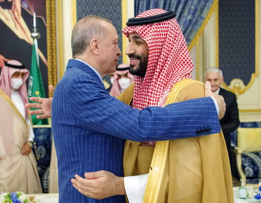 In this photo released by the Saudi Royal Palace, Turkish President Recep Tayyip Erdogan, left, hugs Saudi Arabia's Crown Prince Mohammed bin Salman before a meeting in Jiddah, Saudi Arabia, Thursday, April 28, 2022. Erdogan is visiting Saudi Arabia in a major reset of relations between two regional heavyweights following the slaying of a Saudi columnist in Istanbul. The Turkish presidency said talks in Saudi Arabia will focus on ways of increasing cooperation and the sides will exchange views o