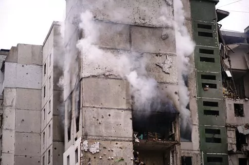 Smoke rises out of an apartments building damaged by shelling in Chernihiv, Ukraine, Thursday, March 3, 2022.  The northern Ukrainian city of Chernihiv has been holding out against Russian forces since the early days of the invasion. But the city located not far from the border with Belarus on the road to Ukraine's capital of Kyiv is surrounded, and the suffering of residents who haven't been able to flee is mounting. (AP Photo/Olga Korotkova)