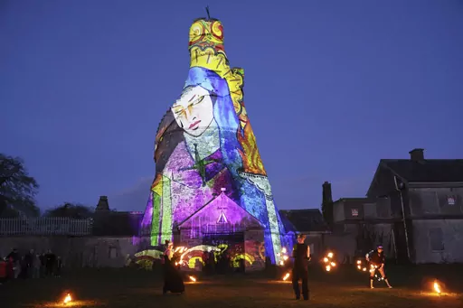 Dancers perform in front of an image of St. Brigid projected onto The Wonderful Barn in Leixlip, Kildare, Ireland, Tuesday, Jan. 31, 2023 during the Herstory Festival of Light. Devotees of St. Brigid in Ireland plan to celebrate on Sunday, Jan. 28, 2024, with the scheduled return of a relic associated with the so-called “matron saint of Ireland” — about a millennium after her remains were removed from her hometown of Kildare. It's part of a series of observances in Ireland and around the w