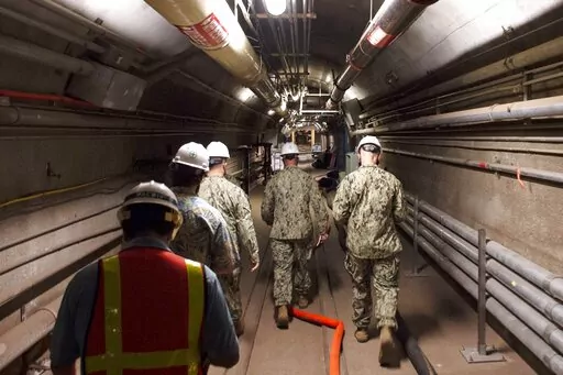 In this Dec. 23, 2021, photo provided by the U.S. Navy, Rear Adm. John Korka, Commander, Naval Facilities Engineering Systems Command (NAVFAC), and Chief of Civil Engineers, leads Navy and civilian water quality recovery experts through the tunnels of the Red Hill Bulk Fuel Storage Facility, near Pearl Harbor, Hawaii. A Navy investigation released Thursday, June 30, 2022 revealed that shoddy management and human error caused fuel to leak into Pearl Harbor's tap water last year, poisoning thousan