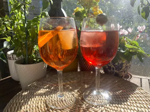 The spritz originated in 19th century Italy. But it has evolved in recent years from Italian aperitif to global cocktail. This wine-based cocktail in its modern form consists of prosecco, digestive bitters and soda water. The prosecco adds fizz to a drink that had traditional been made with non-sparkling white wine. Bitters like Select, Aperol and Campari make the drink glow bright red and orange. Pictured here is an Aperol Spritz, left, and Select Spritz. (AP Photo/Louise Dixon)
