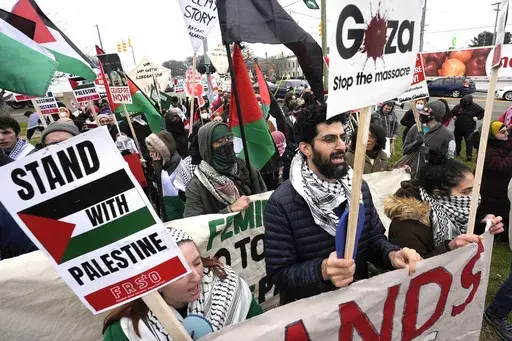 Pro-Palestinian demonstrators march during a visit by President Joe Biden in Warren, Mich., Feb. 1, 2024. Some Arab American leaders in Michigan are expressing cautious optimism about Vice President Kamala Harris' presidential campaign after months of outrage over Biden's handling of the Israel-Hamas war. (AP Photo/Paul Sancya, File)
