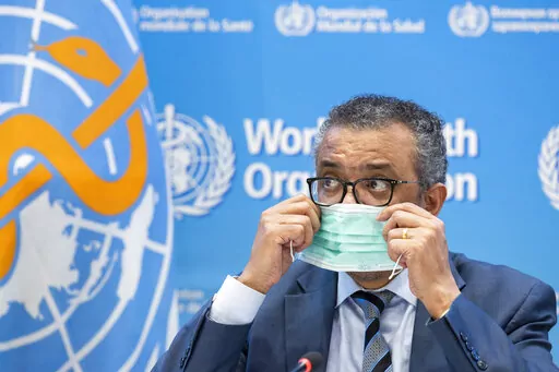 Tedros Adhanom Ghebreyesus, Director General of the World Health Organization (WHO), removes his protective face mask prior to speaking to the media regarding the coronavirus COVID-19 and WHO's global health priorities in 2022, during a new press conference, at the World Health Organization (WHO) headquarters in Geneva, Switzerland, Monday, Dec. 20, 2021. Ghebreyesus has laid out his plans and goals to further fight the coronavirus and other priorities as he pitched his case for a new five-year 