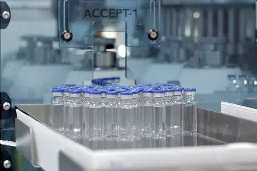 In this image provided by the Serum Institute of India, vials of freshly manufactured Novavax COVID-19 vaccines wait to be labeled in 2022, in Pune, India. The U.S. is getting another COVID-19 vaccine choice as the Food and Drug Administration on Wednesday, July 13, 2022, cleared Novavax shots for adults. (Serum Institute of India for Novavax via AP)