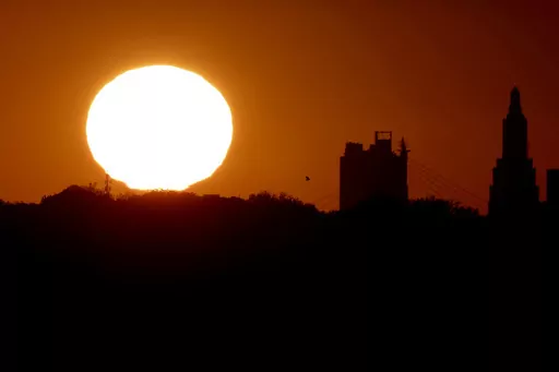 The sun sets beyond the downtown skyline of Kansas City, Mo., as the autumnal equinox marks the first day of fall Sunday, Sept. 22, 2013. During the equinox, the Earth’s axis and its orbit line up so that both hemispheres get an equal amount of sunlight. (AP Photo/Charlie Riedel, File)