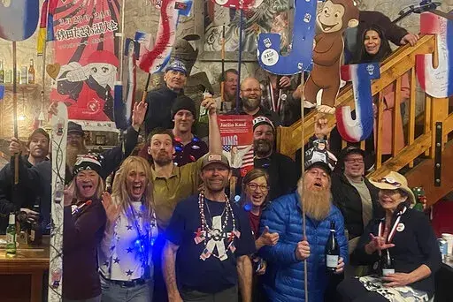 In this photo provided by Patti Kauf, family and friends of Jaelin Kauf, of the United States, celebrate her silver medal in the women's moguls finals at Tetonia Club in Alta, Wyo. Kauf's mom, Patti, and her dad, Scott, are multiple-time champions in the freestyle discipline, from well before it turned into an Olympic pursuit. (Patti Kauf  via AP)