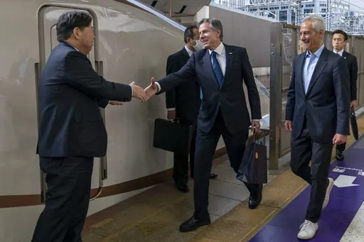 U.S. Secretary of State Antony Blinken, center, accompanied by U.S. Ambassador to Japan Rahm Emanuel, right, is greeted by Japan's Foreign Minister Yoshimasa Hayashi, left, as he boards a train at Tokyo Station in Tokyo, Sunday, April 16, 2023, to travel to Karuizawa, Japan for a G7 Foreign Ministers' Meeting. (AP Photo/Andrew Harnik, Pool)