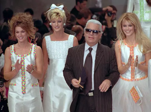 German designer Karl Lagerfeld joins models, from left, American Cindy Crawford, Canadian Linda Evangelista and Claudia Schiffer of Germany after the presentation of his 1996 spring-summer ready-to-wear fashion collection for Chanel in Paris on Oct. 19, 1995. Lagerfeld died in 2019 after dominating the fashion universe into his 80s. Come May 1, his legacy will be on display at the Met Gala and the starry fundraising party's companion exhibition at the Metropolitan Museum of Art's Costume Institu
