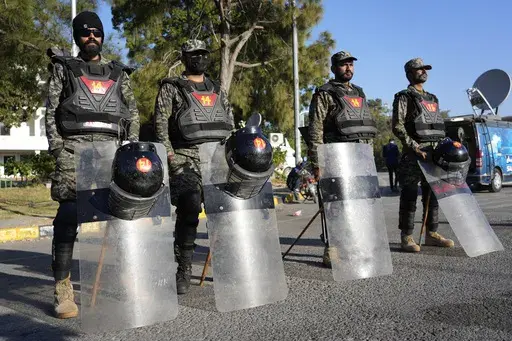 Paramilitary soldiers stand guard along roadside to ensure security in Islamabad, Pakistan, Wednesday, Nov. 27, 2024. (AP Photo/Anjum Naveed)