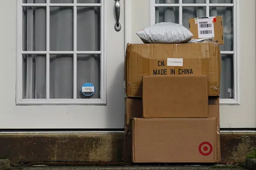 Packages are seen stacked on the doorstep of a residence, Wednesday, Oct. 27, 2021, in Upper Darby, Pa. Conservatives anxious to counter the U.S.’s leading economic adversary have set their sights on a top trade priority for labor unions and progressives: cracking down on the deluge of duty-free packages coming in from China. The changing political dynamic could have major ramifications for small businesses and consumers importing products from China valued at less than $800. (AP Photo/Matt Sl