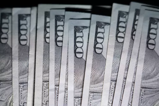 U.S. $100 bills are seen, Thursday, July 14, 2022, in Marple Township, Pa. As we get older it’s important to shift from aggressive, stock-based investments to less risky investments to protect our hard-earned money from market drops. Here’s how to allocate your money to align your investment strategies with your middle years. (AP Photo/Matt Slocum)