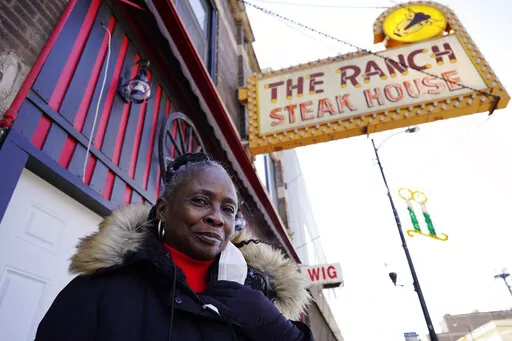 Judy Ware poses for a photo outside of her restaurant in Chicago, Thursday, Jan. 20, 2022. Judy Ware is preparing to resume table service at the Ranch after struggling through the coronavirus pandemic. A fire set during unrest following George Floyd’s killing in Minneapolis destroyed the restaurant’s interior, and takeout-only couldn't sustain the business, which has been operating for more than 50 years. (AP Photo/Nam Y. Huh)