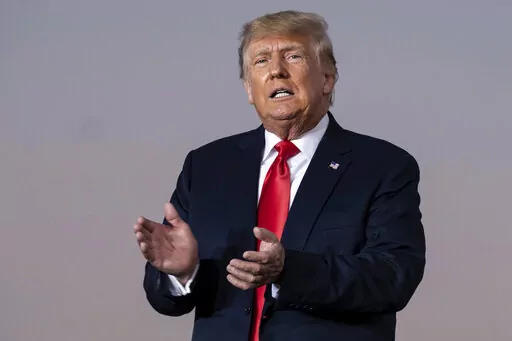 Former President Donald Trump prepares to take the stage during a rally in Perry, Ga., on Sept. 25, 2021.  The New York attorney general’s office says its civil investigation has uncovered evidence that Trump's company used “fraudulent or misleading” asset valuations to get loans and tax benefits. In a court filing late Tuesday, Jan. 18, 2022, Attorney General Letitia James’ office said evidence showed that the Trump Organization routinely misrepresented the value of its properties and g